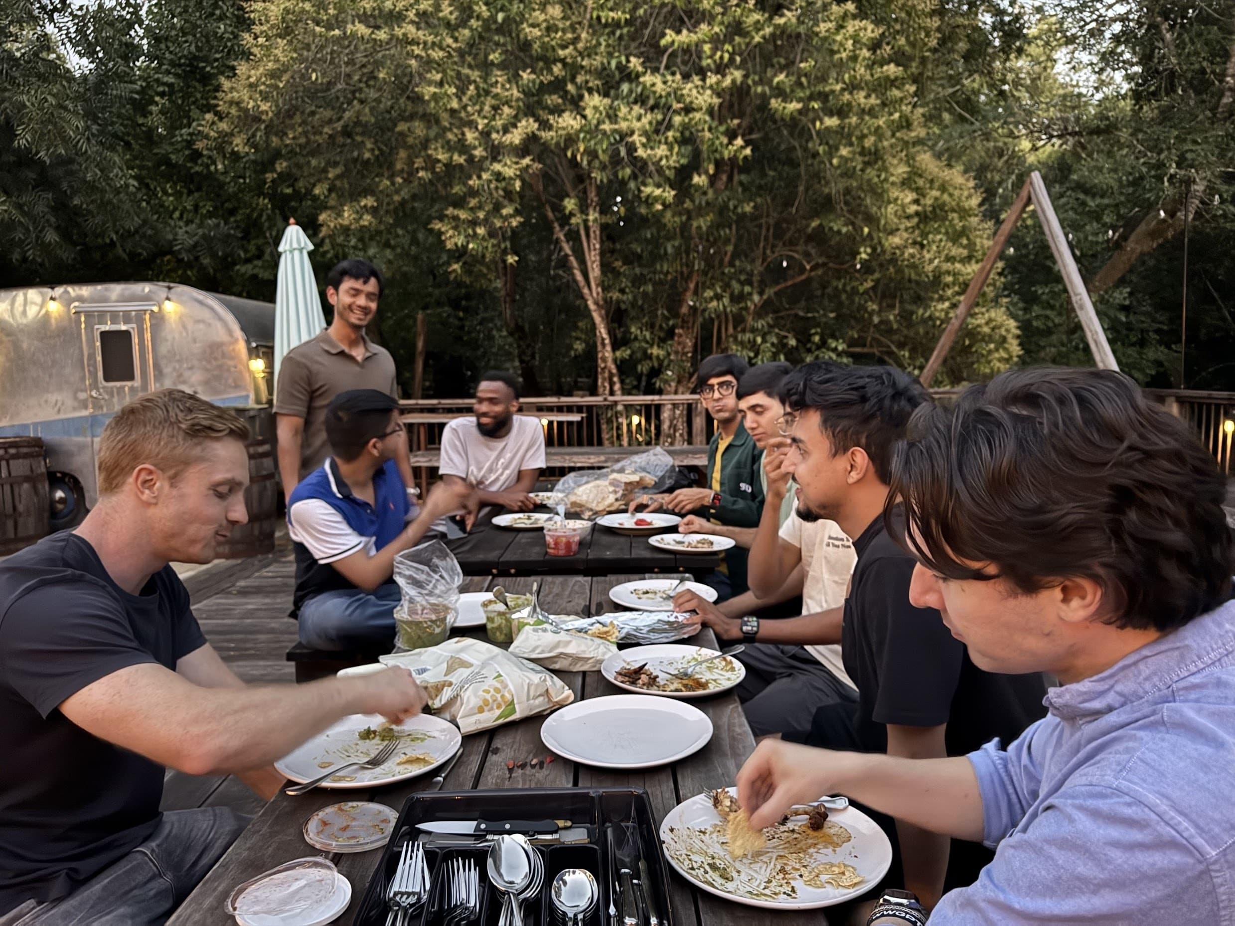 A cohort of solo founders sharing dinner outdoors