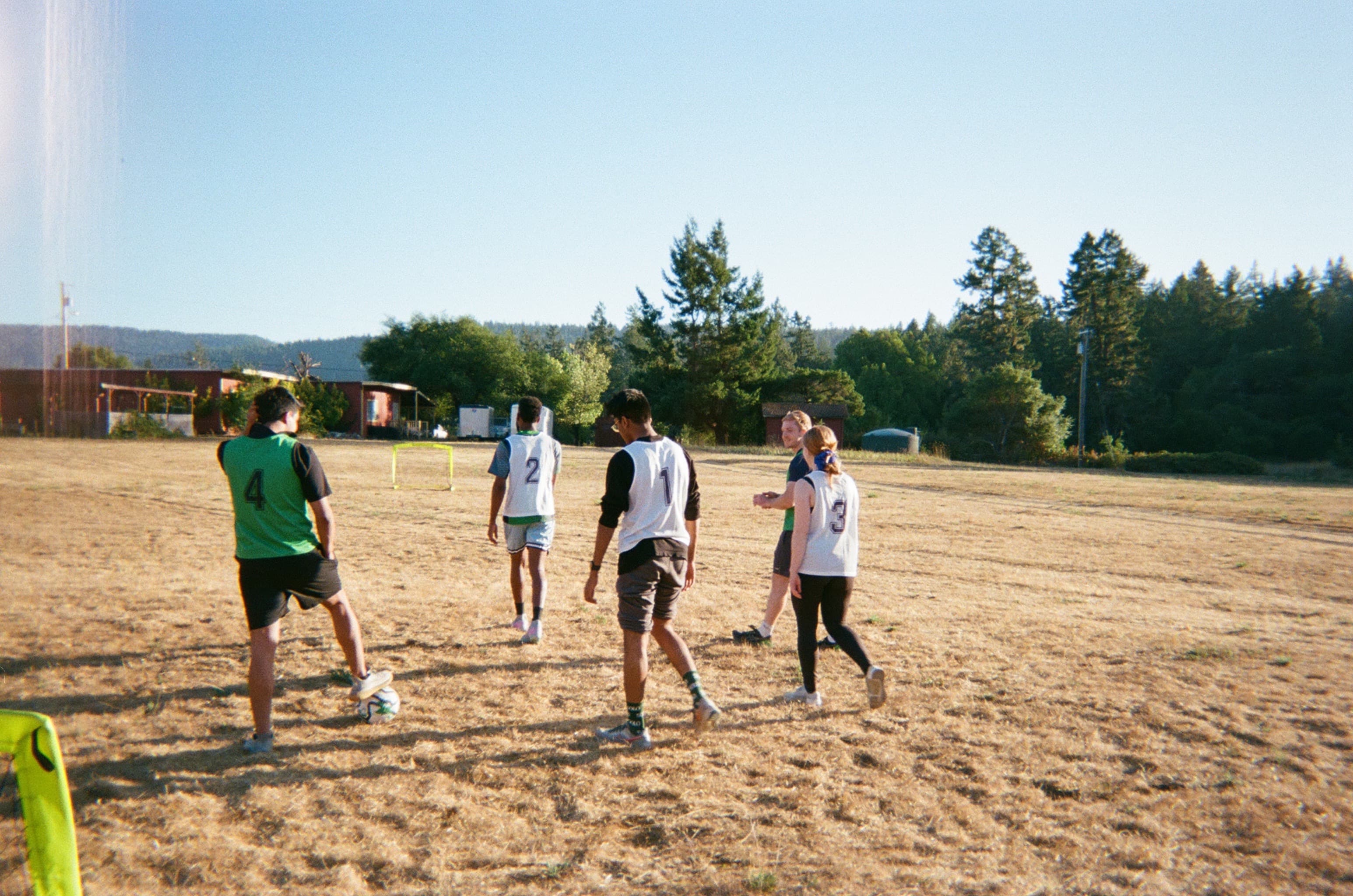 Solo founders playing soccer on a dirt field